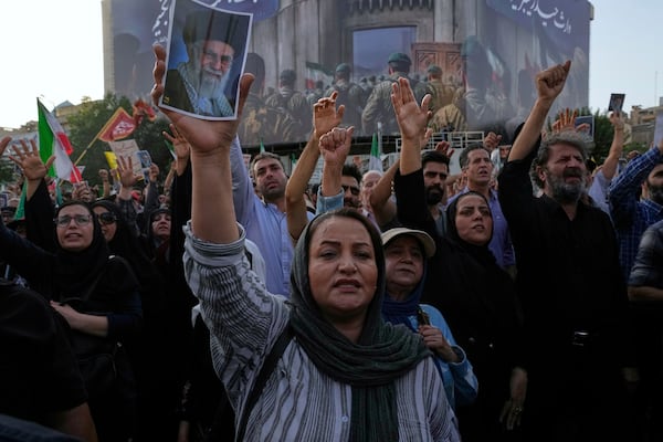 Protesters chant slogans as one of them holds up a poster of the Iranian Supreme Leader Ayatollah Ali Khamenei in a protest following the U.S. attacks on nuclear sites in Iran, in Tehran, Iran, Sunday, June 22, 2025. (AP Photo/Vahid Salemi)