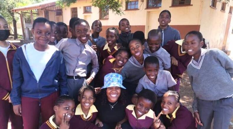 Children from a local village in Botswana gather for a photo with Peace Corps volunteer Shanya McWhinney. (Photo provided by Shanya McWhinney)