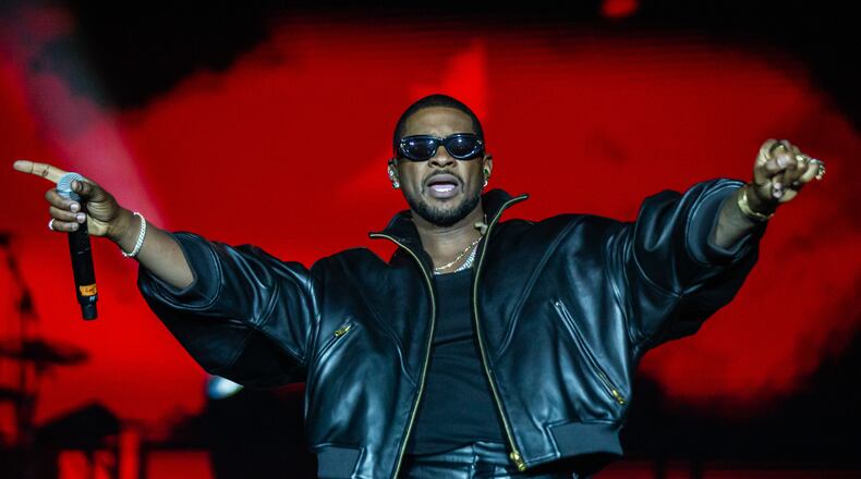 Atlanta singer Usher performs at Piedmont Park in October. He is suing music producer Bryan-Michael Cox and others over a failed Buckhead restaurant deal. (Ryan Fleisher for the AJC)