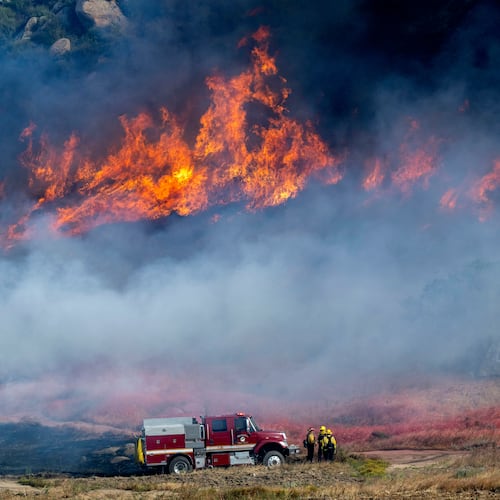 Pechanga Fire Department firefighters monitor the smoky and fast-growing wildfire Springs Fire in Moreno Valley, Calif., Friday, April 3, 2026. (Terry Pierson /The Orange County Register via AP)