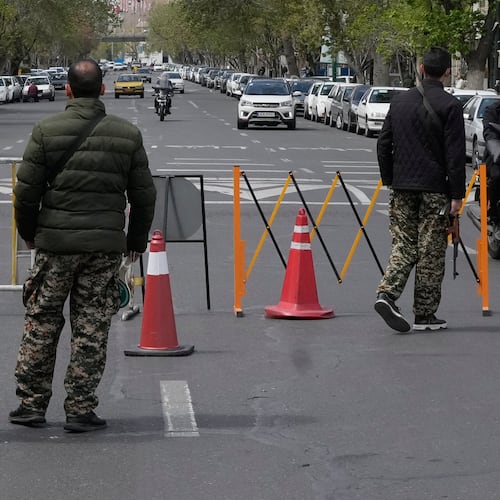 Members of the Basij paramilitary force stand at a checkpoint in Tehran, Iran, Sunday, March 29, 2026. (AP Photo/Vahid Salemi)
