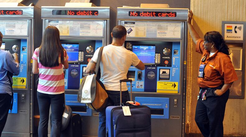 September 4, 2012 ATLANTA A Marta employee was available to assist patrons using fare machines at the Hartsfield Jackson International Airport MARTA station on Tuesday September 4, 2012. MARTA problems with the system's payment machines that began this weekend continued on Tuesday. MARTA Breeze vending machines stopped accepting credit cards on one of the busiest tourism weekends in Atlanta. The cash-only transactions put riders in a bind who are accustomed to uploading cash on their Breeze cards with credit and debit cards. A vendor runs MARTA's payment system and is trying to fix the glitch. KENT D. JOHNSON / KDJOHNSON@AJC.COM