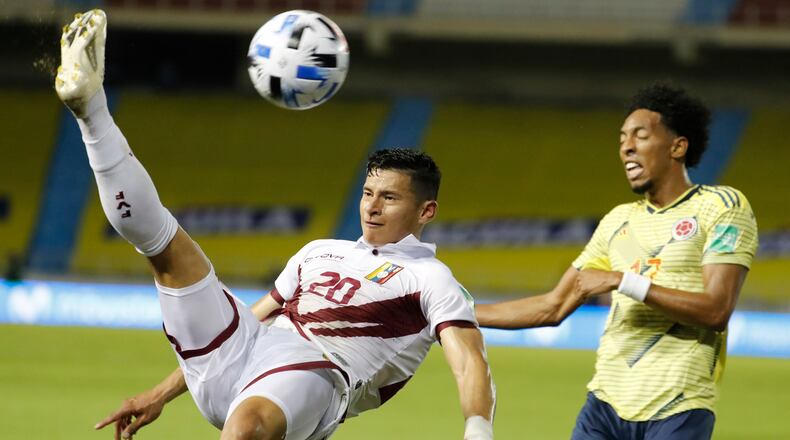 Venezuela's Ronald Hernandez (left) and Colombia's Johan Mojica battle for the ball during a qualifying soccer match for the FIFA World Cup Qatar 2022 Friday, Oct. 9, 2020, in Barranquilla, Colombia. (Mauricio Dueñas/AP)