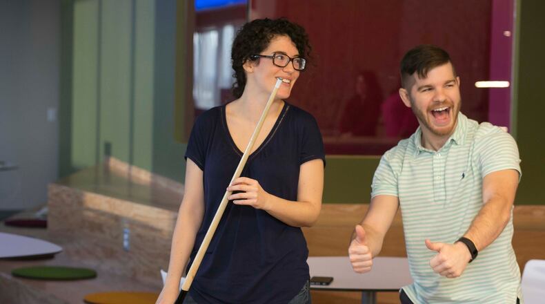 February 4, 2016-ATLANTA: Jozi Hall (left) & Andrew Hotchkiss (both cq) enjoy a game of billiards during a break at Salesforce's Atlanta office. Ping Pong, video games, a massage therapist & yoga classes help the employees enjoy their work environment. It was voted the No 1 top workplace for large companies. (Photo by Phil Skinner)