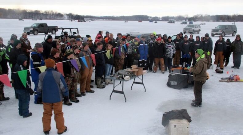 Anglers and coaches assembled for the Kettle Moraine Lake Tip-Up Extravaganza near Dundee, Wis., listen as Ted Bonde of the Wisconsin Interscholastic Fishing Association, right center, announces results from the day-long ice fishing competition. (Paul A. Smith/Milwaukee Journal Sentinel/TNS)