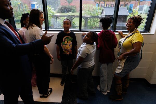 Students at R.N. Fickett Elementary School speak with visitors about the chickens they have in the courtyard on Aug. 7, 2026. (Estela Muñoz/AJC)