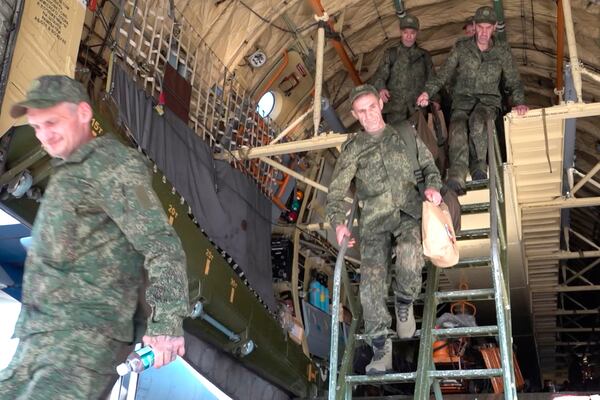In this photo taken from video released by Russian Defense Ministry Press Service on Sunday, May 25, 2025, Russian servicemen leave a plane upon arrival to Chkalovsky airport, outside Moscow, Russia, after returning from captivity by a POWs exchange between Russia and Ukraine. (Russian Defense Ministry Press Service photo via AP)