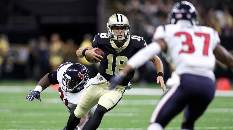 Garrett Grayson (18) of the New Orleans Saints avoids a tackle by  Bryce Jones of the Houston Texans at Mercedes-Benz Superdome on August 26, 2017 in New Orleans, Louisiana.  (Photo by Chris Graythen/Getty Images)