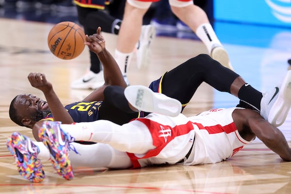 Golden State Warriors' Draymond Green tangles with Houston Rockets' Tari Eason during the first half in Game 4 of an NBA basketball first-round playoff series in San Francisco, on Monday, April 28, 2025. (Scott Strazzante/San Francisco Chronicle via AP)