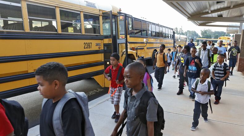 Baggett Elementary School students arrive on Aug. 10 for the first day of the 2015-16 school year. BOB ANDRES / BANDRES@AJC.COM