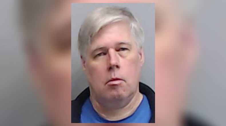 Christopher Guetter, 58, was booked into the Fulton County Jail after his arrest by Roswell police.