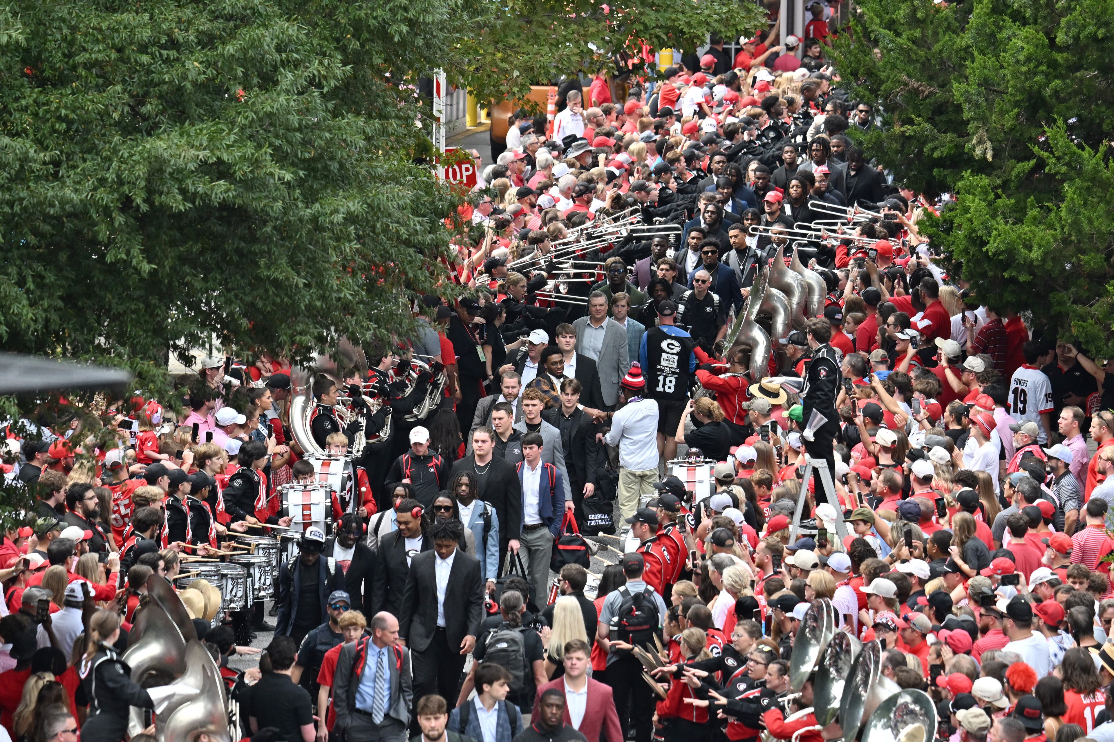 Georgia players and coaching staff arrive during the Dawg Walk before an NCAA football game against Mississippi at Sanford Stadium, Saturday, October 18, 2025, in Athens. (Hyosub Shin/AJC)