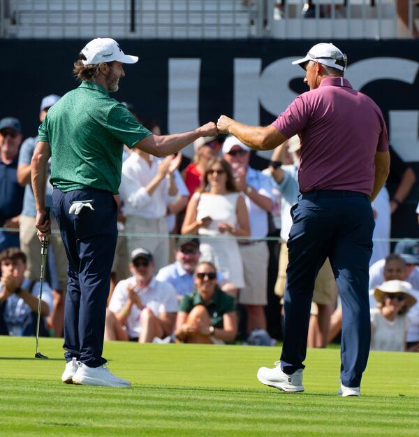 Mark Hensby, left, congratulates Padraig Harrington after Harrington chipped in for a birdie on the 18th hole during the third round of the 45th U.S. Senior Open Championship Saturday, June 28, 2025, at the Broadmoor Golf Club in Colorado Springs, Colo. (Christian Murdock/Colorado Springs Gazette via AP)