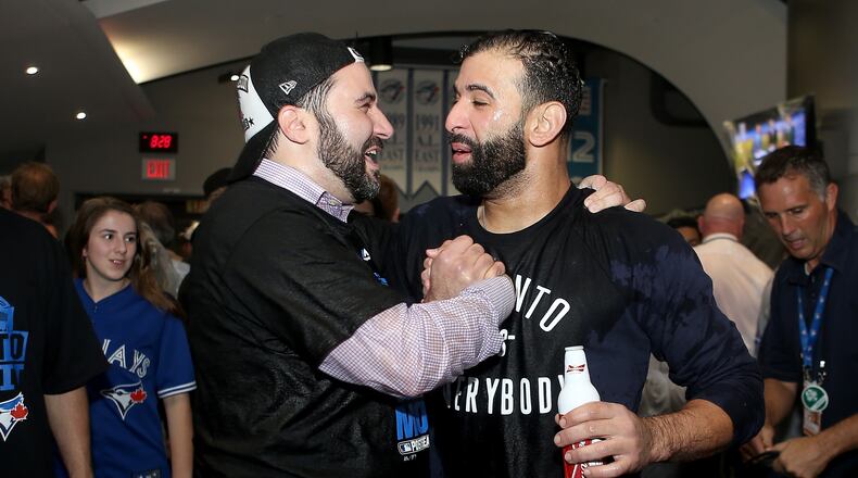 Alex Anthopoulos (left) was Toronto’s general manager in 2015 when the Blue Jays snapped a long postseason drought. He’s pictured celebrating  with Jose Bautista after a division series win against the Rangers. (Photo by Tom Szczerbowski/Getty Images)