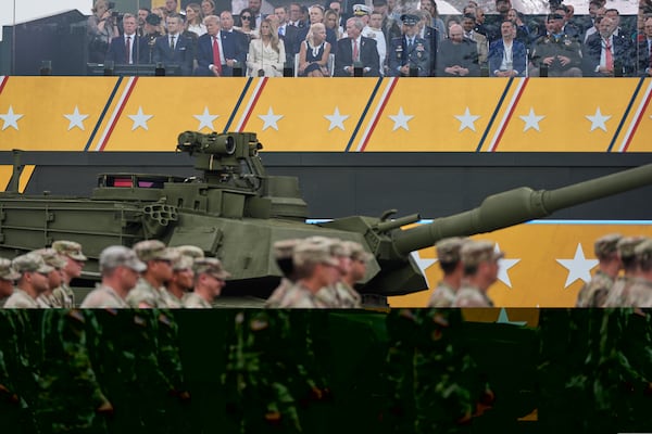 President Donald Trump, first lady Melania Trump and other guests attend a military parade commemorating the Army's 250th anniversary, coinciding with his 79th birthday, Saturday, June 14, 2025, in Washington. (AP Photo/Julia Demaree Nikhinson)