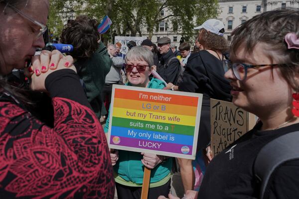 Campaigners take part in a rally organised by trans rights groups, trade unions, and community organisations following the Supreme Court ruling on the definition of a woman in equalities law, at Parliament Square, central London, Saturday April 19, 2025. (AP Photo/Alastair Grant)