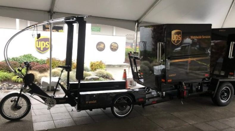 A UPS truck will drop off a trailer carrying four containers. The eBikes then hitch up an individual container and make deliveries. (Via KIRO7.com)