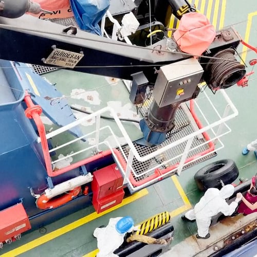 Health workers get off the Dutch-flagged MV Hondius, a cruise ship carrying nearly 150 people as it remains off Cape Verde on Monday, May 4, 2026 after three passengers died and several others fell seriously ill in a suspected hantavirus outbreak. (Qasem Elhato via AP)