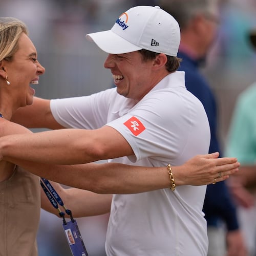 Matt Fitzpatrick, of England, right, hugs his wife Katherine Gaal after winning the RBC Heritage golf tournament Sunday, April 19, 2026, in Hilton Head, S.C. (AP Photo/Mike Stewart)