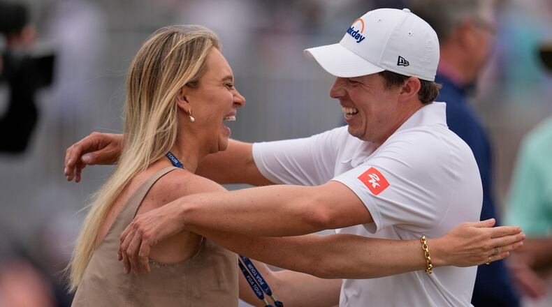 Matt Fitzpatrick, of England, right, hugs his wife Katherine Gaal after winning the RBC Heritage golf tournament Sunday, April 19, 2026, in Hilton Head, S.C. (AP Photo/Mike Stewart)