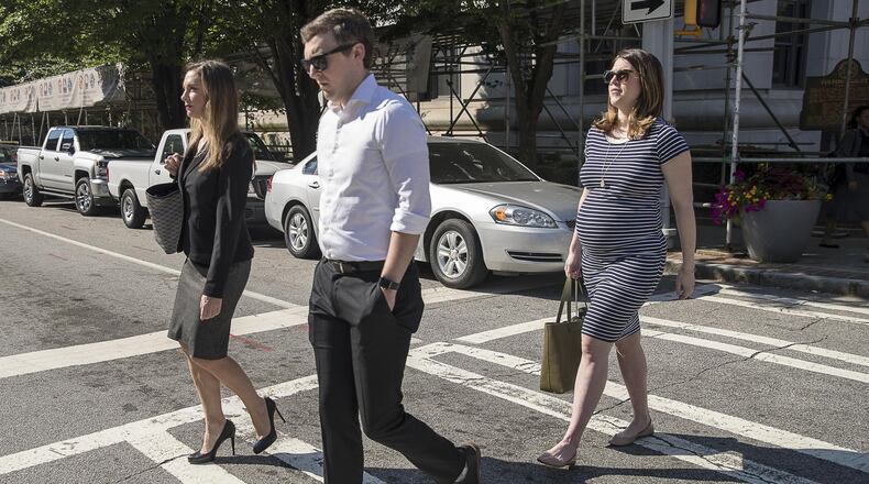 Jenna Garland (right), press secretary for former Atlanta Mayor Kasim Reed, leaves the Fulton County Courthouse with her attorney, Jennifer Little (left). Garland is the first government official ever criminally charged in Georgia for violations of the state’s open records law. (Alyssa Pointer/alyssa.pointer@ajc.com)
