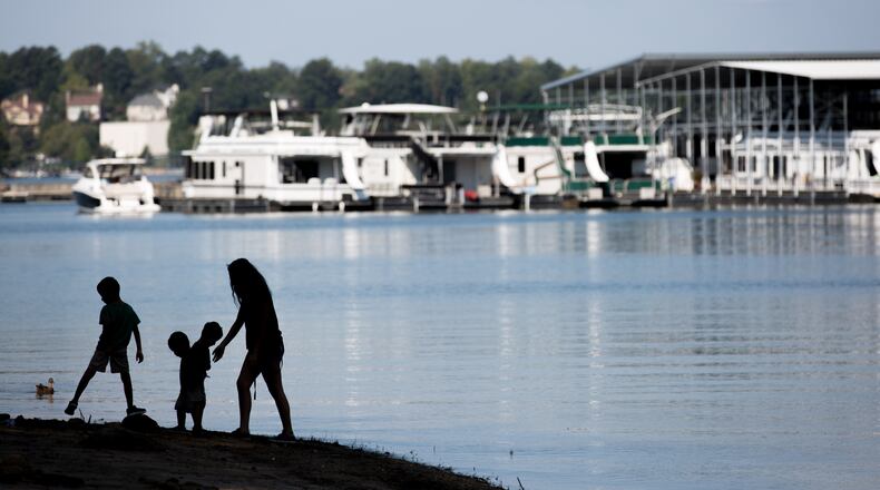A family walks along the beach at Lake Lanier on Labor Day, Monday, Sept. 5, 2016, in Flowery Branch, Ga. BRANDEN CAMP/SPECIAL