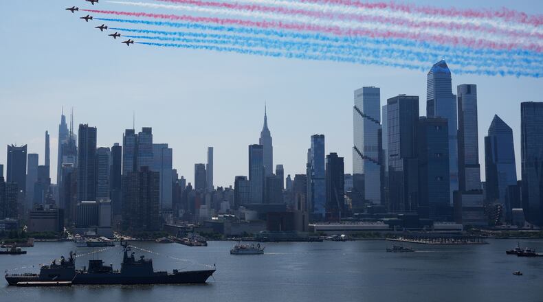 Military planes perform a flyover of the Hudson River, above the the Manhattan skyline, as seen from Weehawken, N.J., Saturday, July 4, 2026. (AP Photo/Seth Wenig)