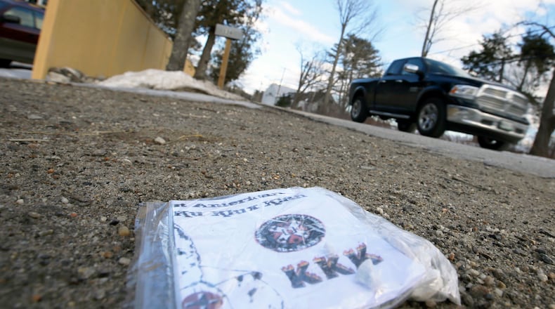 A Ku Klux Klan flier lying at the end of a driveway.