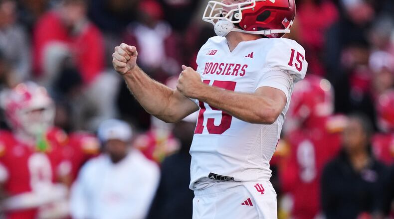 FILE - Indiana quarterback Fernando Mendoza (15) celebrates after throwing a touchdown pass to wide receiver Omar Cooper Jr. during the first half of an NCAA college football game against Maryland, Saturday, Nov. 1, 2025, in College Park, Md. (AP Photo/Stephanie Scarbrough, File)