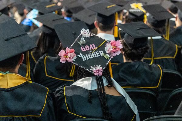 Graduates listen to the commencement speaker during their graduation at Kennesaw State University on Tuesday, May 7, 2014.  (Steve Schaefer / AJC)