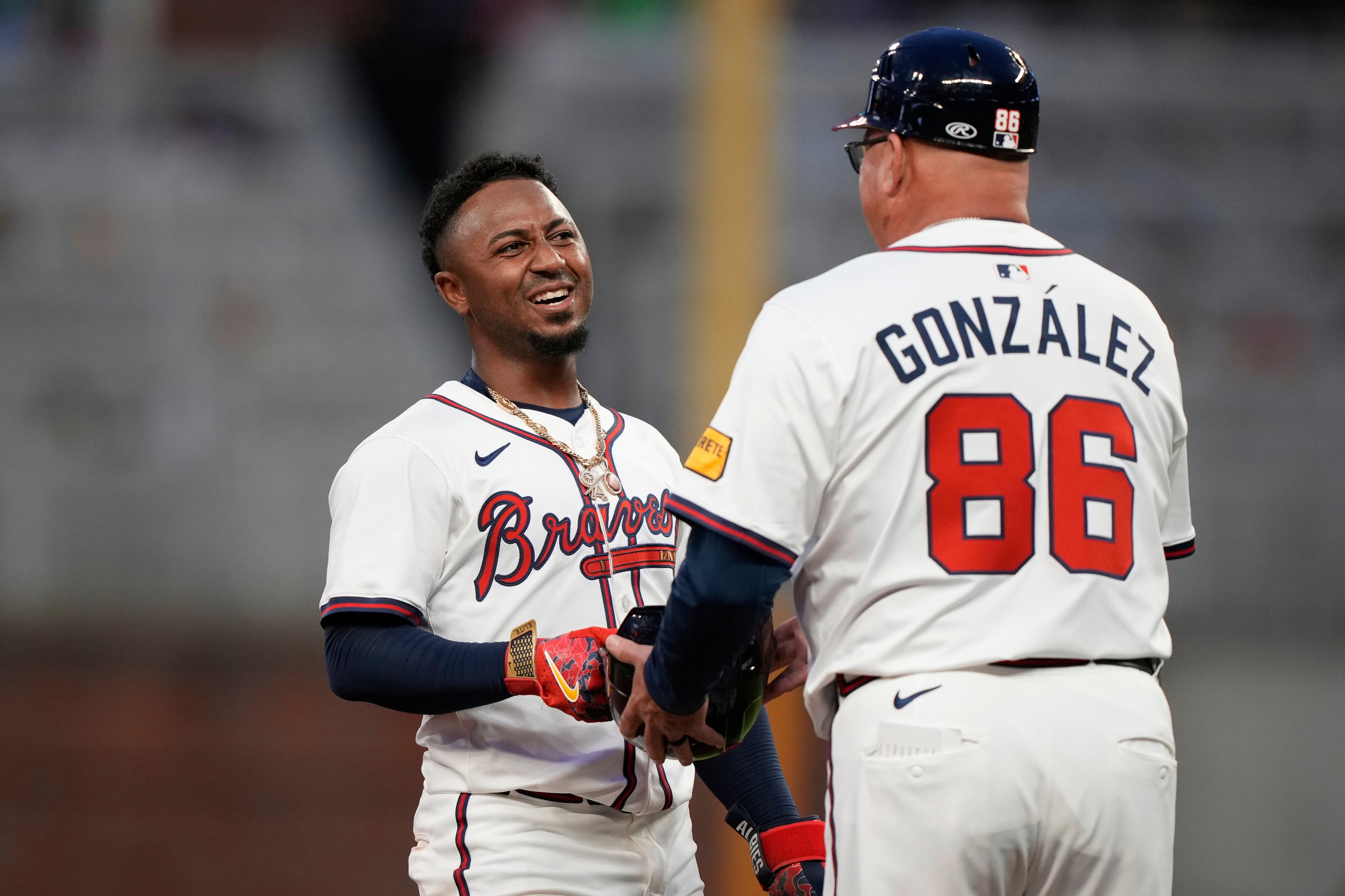 Braves second baseman Ozzie Albies (left) speaks with third base coach Fredi González during the second inning of a baseball game against the New York Mets on Tuesday, June 17, 2025, in Atlanta. (Brynn Anderson/AP)
