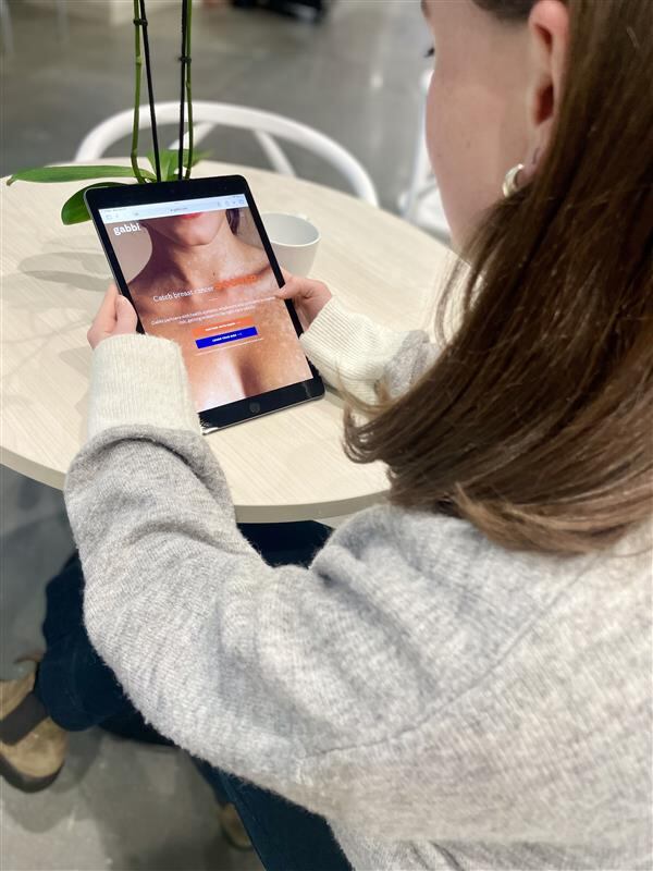 A Catalyst team member shows how women can use Gabbi's breast cancer screening tools.