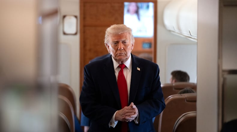 President Donald Trump arrives to speak to reporters aboard Air Force One en route from Joint Base Andrews, Md., to Eau Claire, Wis., Friday, June 5, 2026. (AP Photo/Mark Schiefelbein)