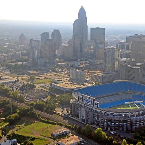 FILE - In this Aug. 16, 2012 file photo, the skyline of Charlotte, N.C., rises behind Bank of America Stadium in this aerial photo. (AP Photo/Chuck Burton, File)
