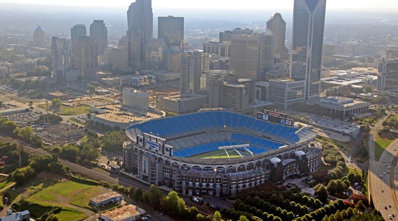 FILE - In this Aug. 16, 2012 file photo, the skyline of Charlotte, N.C., rises behind Bank of America Stadium in this aerial photo. (AP Photo/Chuck Burton, File)