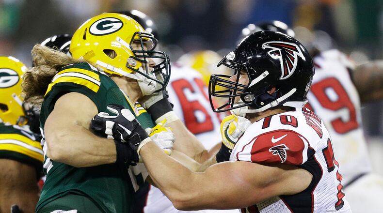 The Falcons Jake Matthews locks up with cousin Clay Matthews in their 2014 meeting in Green Bay. (Mike McGinnis/Getty Images)