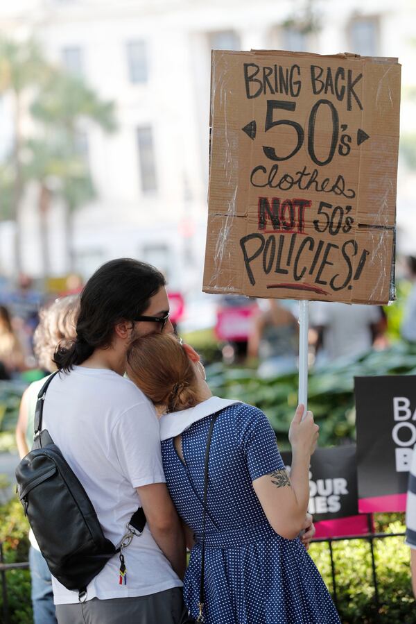 A couple stands together during Friday's abortion rights rally in Johnson Square.