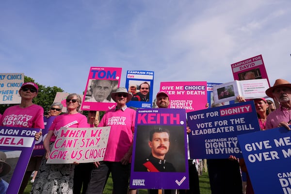 Demonstrators for assisted dying hold banners outside the Parliament in London, Friday, June 20, 2025, as British lawmakers are set to vote Friday on whether to back a bill to help terminally ill adults end their lives in England and Wales. (AP Photo/Kirsty Wigglesworth)
