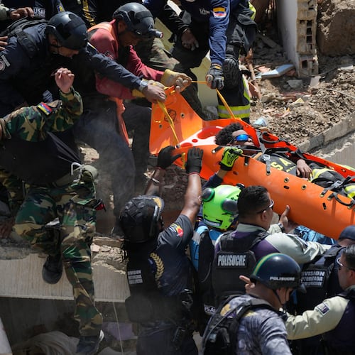 Rescue workers pull Moises Calzadilla, 11, from the rubble three days after earthquakes struck La Guaira, Venezuela, Saturday, June 27, 2026. (AP Photo/Fernando Vergara)