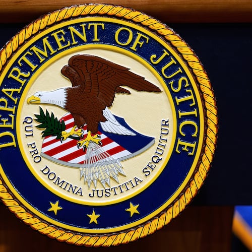 FILE - The U.S. Department of Justice logo is seen on a podium before a news conference at the Justice Department in Washington, on May 6, 2025. (AP Photo/Julia Demaree Nikhinson, File)