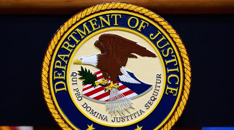 FILE - The U.S. Department of Justice logo is seen on a podium before a news conference at the Justice Department in Washington, on May 6, 2025. (AP Photo/Julia Demaree Nikhinson, File)