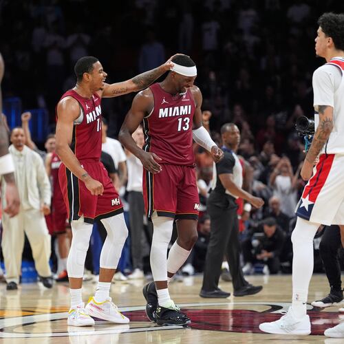 Miami Heat center Bam Adebayo (13) is congratulated by forward Keshad Johnson (16) after reaching 83 points, the second-highest single game total in NBA history, in the second half of an NBA basketball game against the Washington Wizards, Tuesday, March 10, 2026, in Miami. (AP Photo/Rebecca Blackwell)