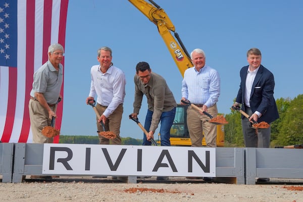 Gov. Brian Kemp, Rivian founder RJ Scaringe and others perform a moving corporate rite of honor: Shoveling a single spade of dirt and putting it back down. 