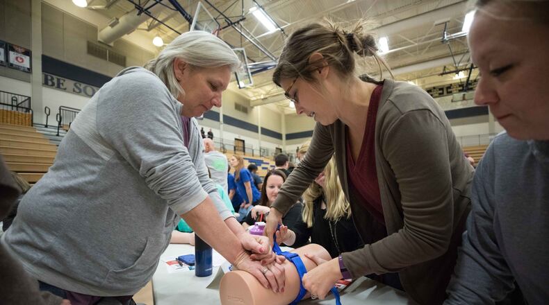 Nickajack elementary teachers Joan Lunsfurd, left, Callie Quinn, center, practice using a tourniquet as April Mitchell watches during an active shooter training seminar at Marietta High School, Monday, Feb. 26, 2018, in Marietta, Ga. BRANDEN CAMP/SPECIAL