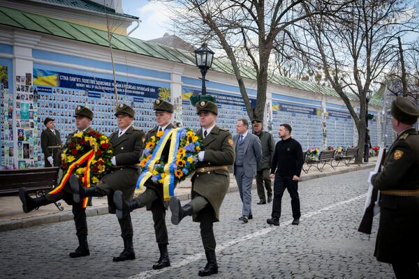 In this photo provided by the Ukrainian Presidential Press Office, Ukrainian President Volodymyr Zelenskyy , center right, and Belgium's Prime Minister Bart de Wever, center left, attend a flower laying ceremony at the Memory Wall of Fallen Defenders of Ukraine in Kyiv, Ukraine, Tuesday, April 8, 2025. (Ukrainian Presidential Press Office via AP)