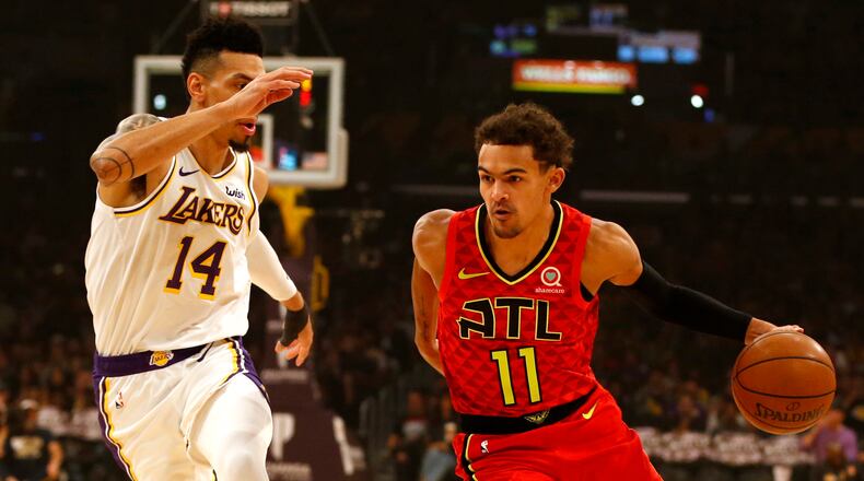 Hawks guard Trae Young (right) moves the ball down the court as the Lakers' Danny Green trails during the first half Nov. 17, 2019, at Staples Center in Los Angeles.