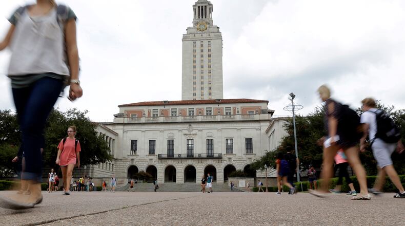FILE - Students walk through the University of Texas at Austin campus near the school's iconic tower, Sept. 27, 2012, in Austin, Texas. (AP Photo/Eric Gay, File)