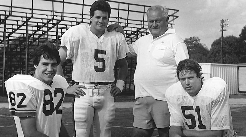 Legendary Georgia placekicker Kevin Butler (No. 5) poses with holder Jimmy Harrell (82), snapper Paul Messer (51) and and longtime UGA kicking coach Bill Hartman. The three players combined to make a 60-yard, game-winning field goal against Clemson in 1984. That kick remains the longest in school history. (Photo provided by UGA Athletics)