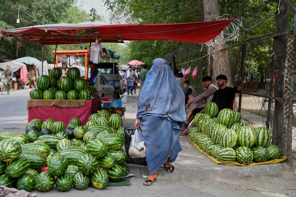 A woman shops in a market in Kabul, Afghanistan, Thursday, June 5, 2025. (AP Photo/Ebrahim Noroozi)