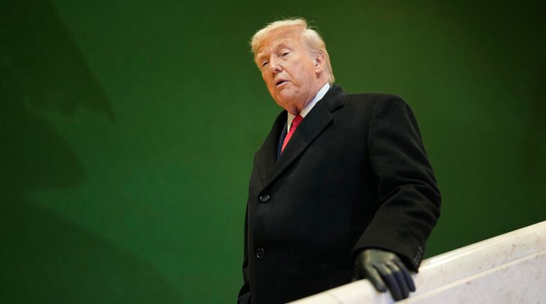 President Donald Trump walks down stairs after a meeting during the Annual Meeting of the World Economic Forum in Davos, Switzerland, Wednesday, Jan. 21, 2026. (AP Photo/Markus Schreiber)
